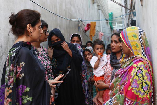 Professor Jehan Ara discussing breast cancer awareness with community women.