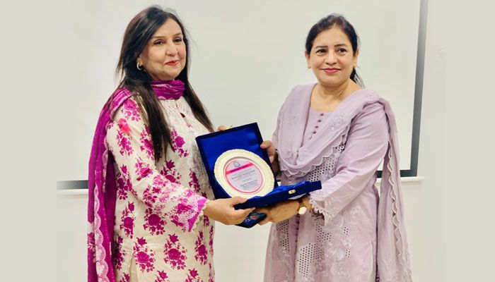 Professor Jehan Ara presenting a certificate to one of the speakers.