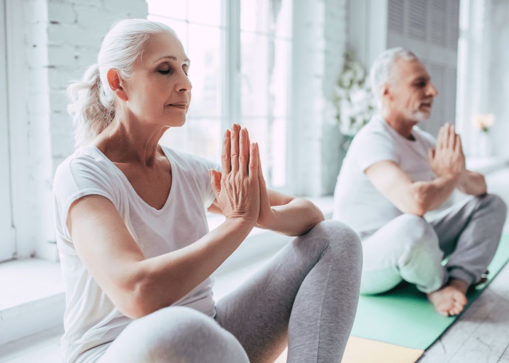 Older adults doing yoga to prevent back pain